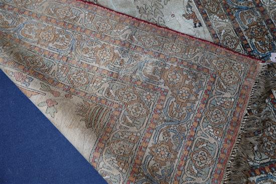 A 19th century Persian ivory ground pictorial rug, depicting a Shah, 6ft 9in by 4ft 7in.